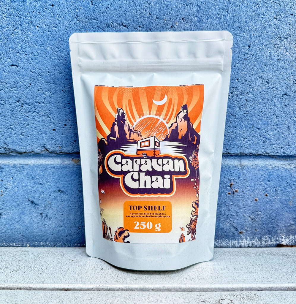 Caravan Chai packaging against a blue wall