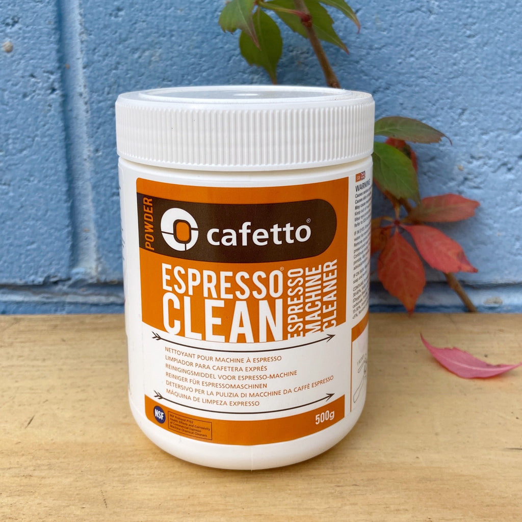 A jar of Cafetto Espresso Clean machine cleaner with a label that includes the product name and a measuring scoop.