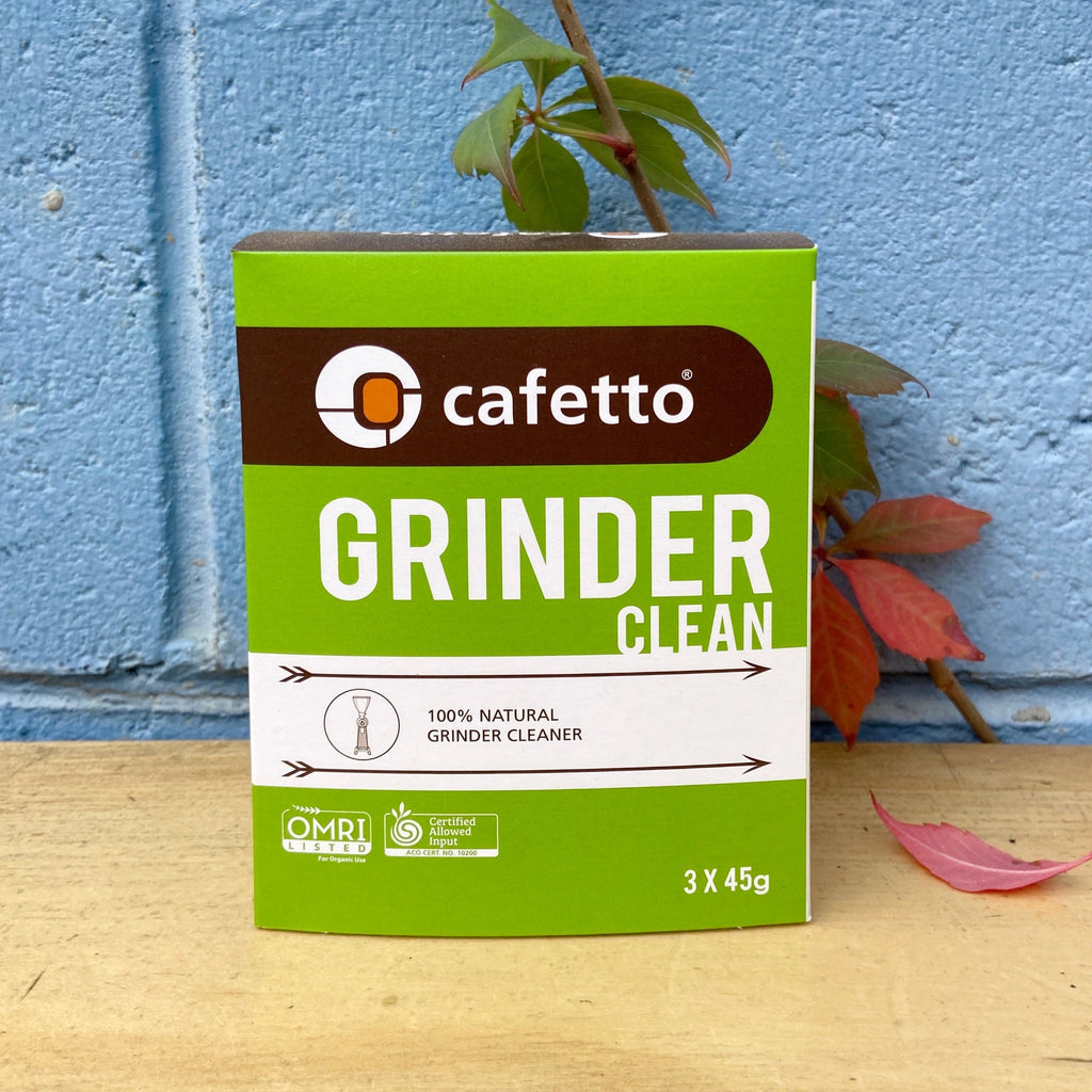 A green and brown box of Cafetto Grinder Clean, indicating it is a 45g sachet with a natural grain cleaner formula.