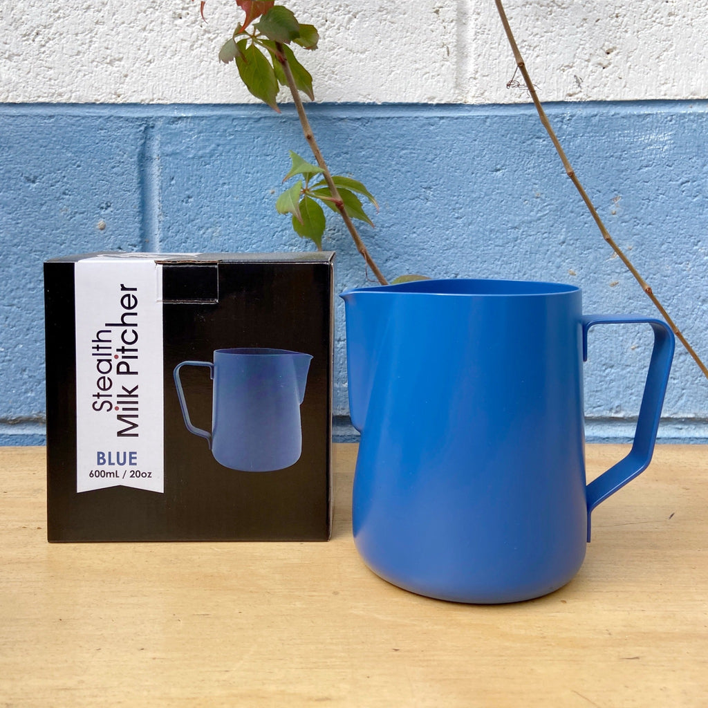 A blue Rhino Stealth Milk Jug with a capacity of 600 ML, displayed next to its black packaging box with a label reading 'Stealth Milk Pitcher 600ml'.